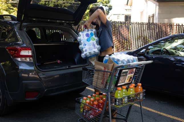 A shopper loads cases of water and bottles of PepsiCo Inc. brand Gatorade beverages into a car during a heatwave in Portland, Oregon, U.S., on Saturday, June 26, 2021.