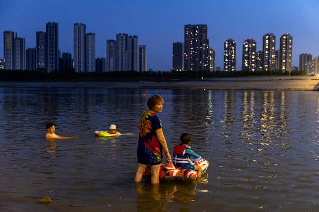 People swim in the Han River in Wuhan, Hubei Province, on August 19. 