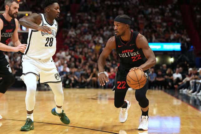 Nov 16, 2023; Miami, Florida, USA;  Miami Heat forward Jimmy Butler (22) drives to the basket as Brooklyn Nets forward Dorian Finney-Smith (28) defends in the first half at Kaseya Center.