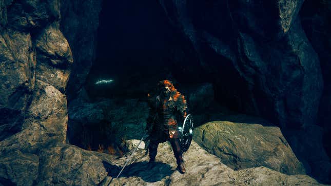 The Defiler stood in front of an open cave.