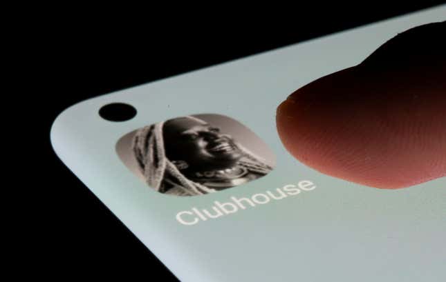 A person's thumb presses on the Clubhouse app icon on their phone.