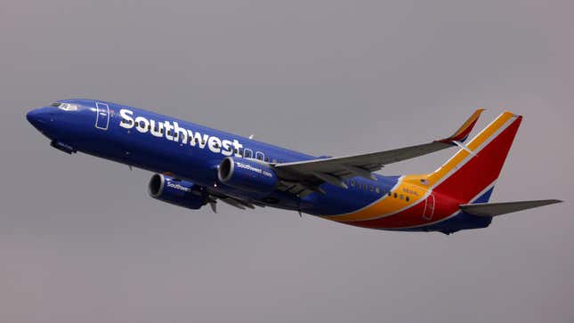 A Southwest Airlines plane flies in front of a gray sky