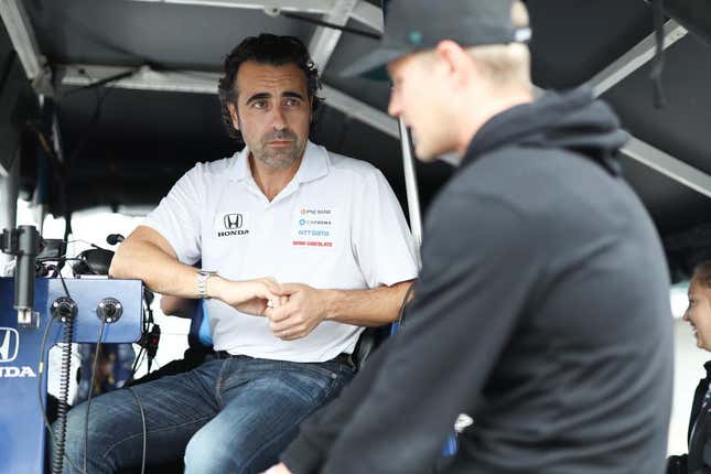 Dario Franchitti sits on the Chip Ganassi Racing pit box while speaking to driver Marcus Ericsson.