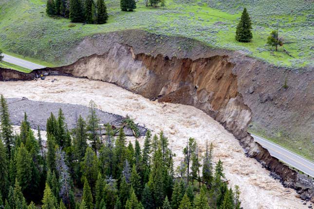 This aerial photo provided by the National Park Service shows a flooded  out North Entrance Road, of Yellowstone National Park in Gardiner,  Mont., on June 13, 2022.