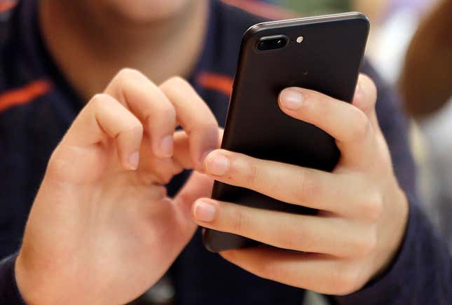 FILE - In this Sept. 16, 2017, file photo, a person uses a smart phone in Chicago. Bank impersonations are the top reported type of text message scam. Learn what to look out for so you can avoid bank-impersonation scams and keep your money safe. (AP Photo, File)