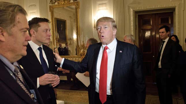 Trump advisor Steve Bannon (L) watches as US President Donald Trump greets Elon Musk, SpaceX and Tesla CEO, before a policy and strategy forum with executives in the State Dining Room of the White House February 3, 2017 in Washington, DC.