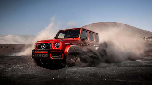 A photo of Mercedes G Wagen truck driving in dirt. 