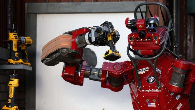 Team Tartan Rescue’s CHIMP (CMU Highly Intelligent Mobile Platform) robot uses a hand-held power tool during the cutting task of the Defense Advanced Research Projects Agency (DARPA) Robotics Challenge at the Fairplex June 6, 2015 in Pomona, California.