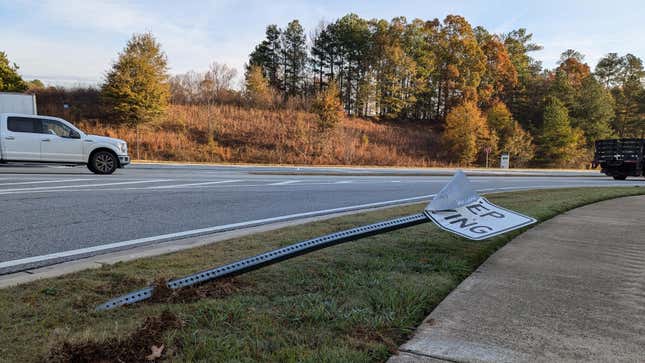 Keep Moving sign that's been hit by a car