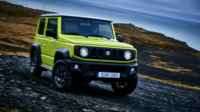 a green Suzuki Jimny on an unpaved road