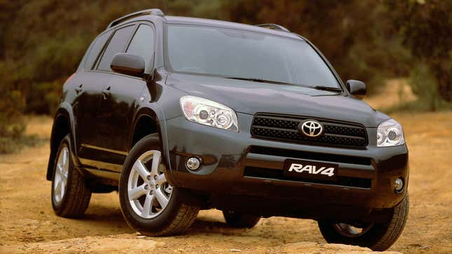 A photo of a black Toyota Rav4 SUV parked on dirt. 