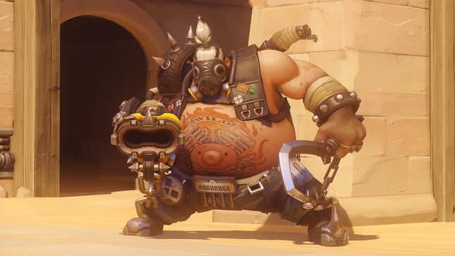 Roadhog stands with his hook and shotgun.