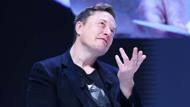 A photo of Elon Musk speaking on stage. 