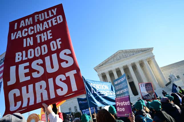 Abortion rights advocates and anti-abortion protesters demonstrate in front of the US Supreme Court in Washington, DC, on December 1, 2021. - The justices weigh whether to uphold a Mississippi law that bans abortion after 15 weeks and overrule the 1973 Roe v. Wade decision. (Photo by Jim WATSON / AFP) (Photo by JIM WATSON/AFP via Getty Images)