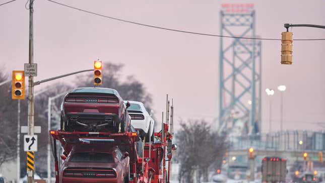 Trucks drive down the road towards the Ambassador Bridge border crossing in Windsor, Ontario, on February 14, 2022. - Trucker-led demonstrations against Canada’s COVID-19 restrictions disrupted traffic on the Ambassador Bridge for seven days, but authorities on February 13, 2022, cleared out the protestors. 