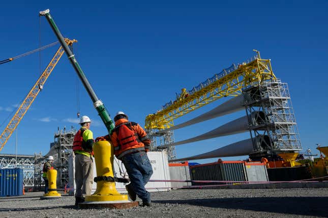 File - A generator and its blades are prepared to head to the open ocean for the South Fork Wind farm from State Pier in New London, Conn., Dec. 4, 2023. On Thursday, the government issues the first of three estimates of GDP growth in the United States during the October-December quarter.(AP Photo/Seth Wenig, File)