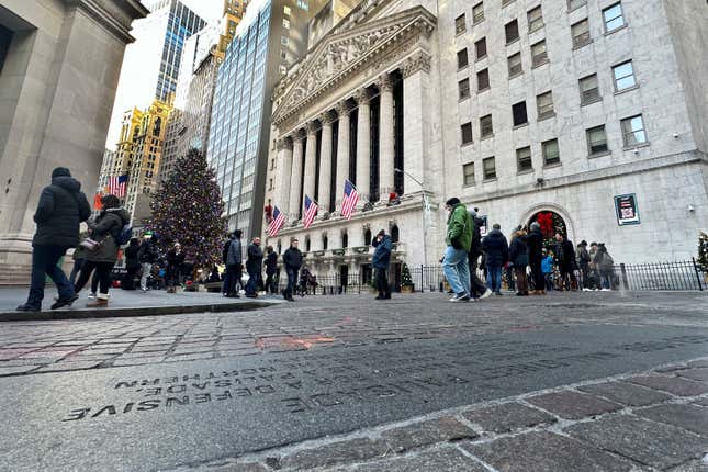 People gather near the New York Stock Exchange on Tuesday, Jan. 2, 2024 in New York. The S&amp;P 500 was lower in midday trading after pulling to the brink of its all-time high set roughly two years ago. (AP Photo/Peter Morgan)