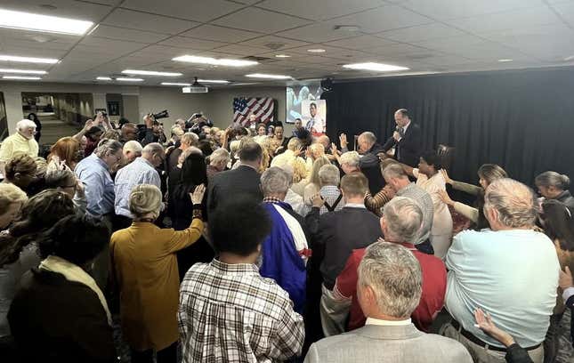 Worshippers at First Baptist Church in Atlanta surround Herschel Walker on Oct. 4, 2022.