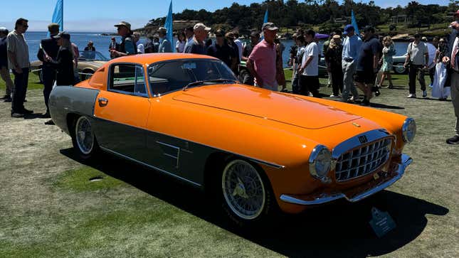 Front 3/4 view of an orange and grey 1954 Ferrari 375 MM Ghia Coupe