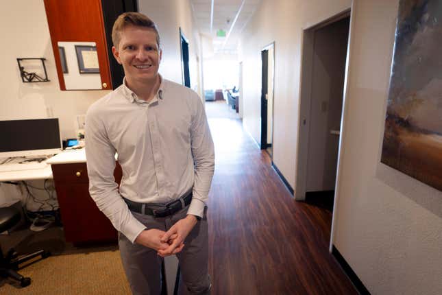 Optometrist Hunter Morgan poses in his offices on Friday, March 1, 2024, in Encinitas, Calif. When Morgan bought an optometry practice in San Diego three years ago, one of the first things he did was start accepting patients who were enrolled in Medicaid — the government-funded health insurance program for the poor and the disabled. Just five months later, Morgan said, he had to stop treating Medicaid patients because of the paltry pay. He charges $175 for eye exams, but the most he could get from Medicaid was about $40. (AP Photo/Gregory Bull)