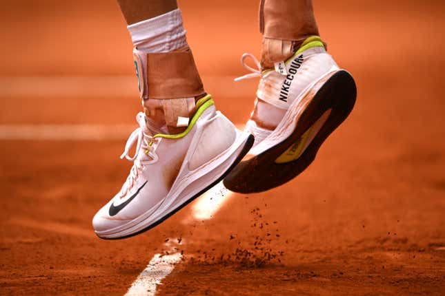 Clay falls from a pair of Nike shoes on June 04, 2024 in Paris, France. 