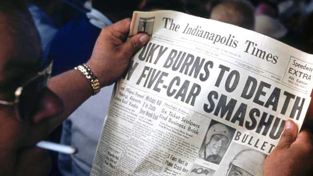 A spectator reads a copy of the The Indianapolis Times 'Speedway Extra', 4th Edition, reporting the death of driver Bill Vukovich with the headline: "Vuky burns to death in five-car smashup", at the Indianapolis Speedway in Indianapolis, Indiana, 30th May 1955.