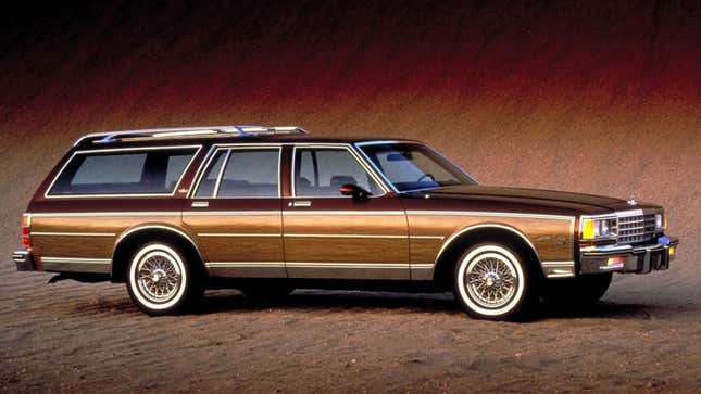 A photo of a brown Chevrolet Caprice in a studio. 