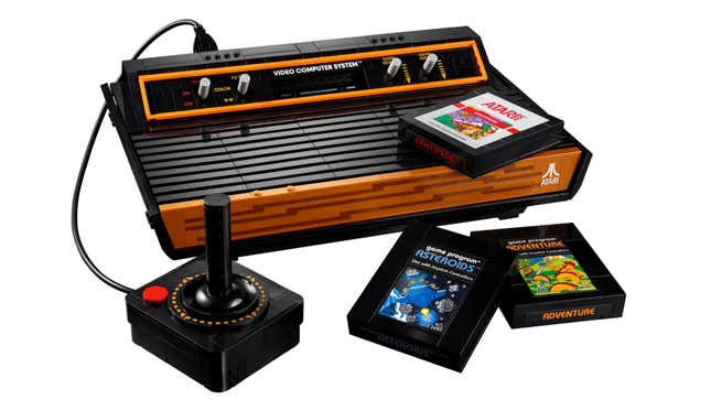 A Lego Atari 2600, with its joystick, and three Lego cartridges.