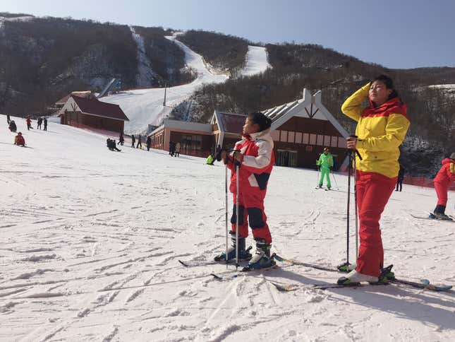 FILE - A mother and her daughter take a rest on the slopes at the Masik Pass ski resort in North Korea on Jan. 28, 2018. Russian tourists going on a ski trip will be the first international travelers to visit North Korea since the country&#39;s borders closed in 2020 amid the global pandemic lockdown, according to a report on the Russian state-run Tass news agency. (AP Photo/Eric Talmadge, File)