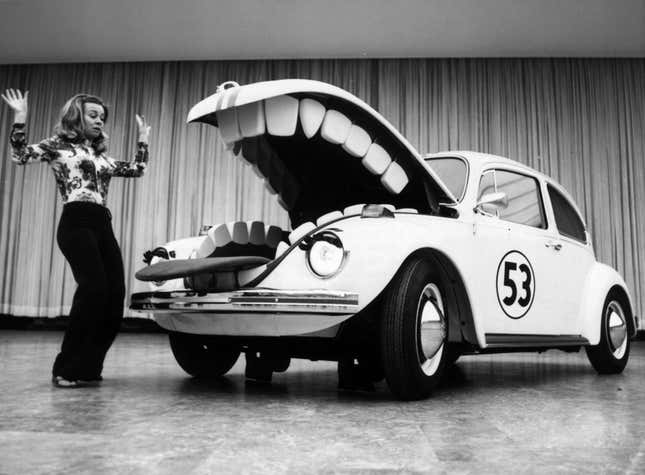 Herbie, the anthropomorphic Volkswagen Beetle featured in the Disney film 'The Love Bug' and its sequels, terrorises a young woman at a motorshow in Berlin, 23rd June 1972