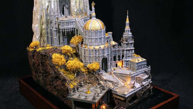 A papercraft model of Leyndell's Royal Capital from Elden Ring is seen sitting on a wooden base.