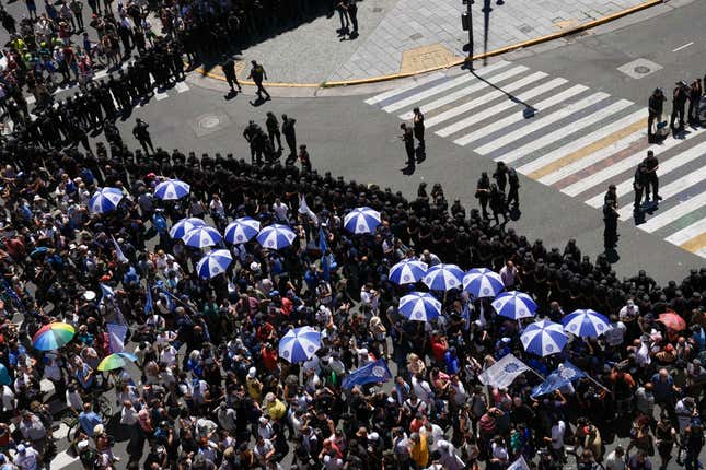 People gather outside Congress during a national strike to protest the economic and labor reforms proposed by Argentine President Javier Milei in Buenos Aires, Argentina, Wednesday, Jan. 24, 2024. (AP Photo/Rodrigo Abd)