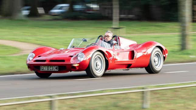 A photo of a recreation Bizzarrini P538 being driven on a road from a front-quarter angle.