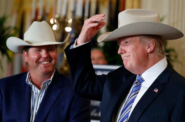 Trying on a Stetson hat.