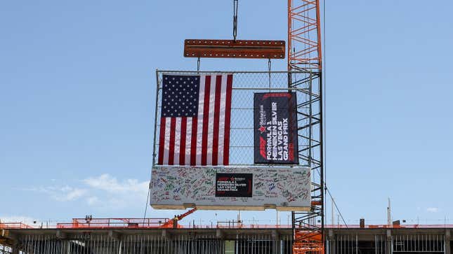 Construction workers lift a track safety barrier signed by executives to the top of the Las Vegas Grand Prix paddock building during a topping out event on April 13, 2023 in Las Vegas, Nevada. The Formula 1 Las Vegas Grand Prix inaugural race weekend is scheduled to take place November 16-18, 2023, with the race itself to begin on the night of November 18