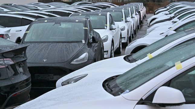 New Model Y electric vehicles are parked in the early morning in a parking lot at Terminal 5 of the capital's Berlin-Brandenburg Airport.
