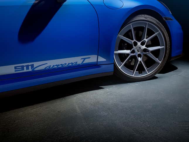 Front wheel and side decal of a blue 2025 Porsche 911 Carrera T cabriolet