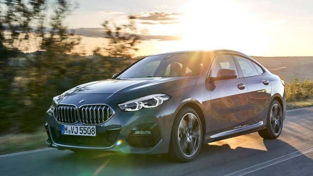 Front 3/4 of a BMW 2 series gran coupe driving in front of a sunset