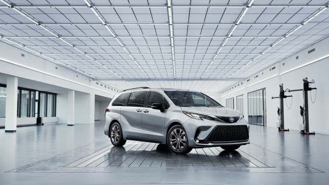 A photo of a silver Toyota Sienna minivan in a studio. 