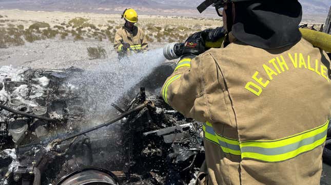 Firefighters drenching what remains of the delivery truck.