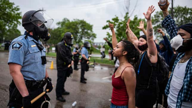 Protesters and police face each other during a rally for George Floyd in Minneapolis on May 26, 2020.
