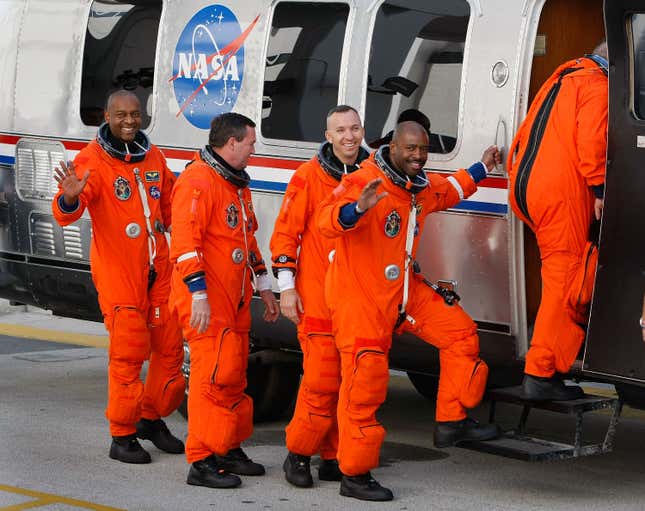 CAPE CANAVERAL, FL - NOVEMBER 16: (R-L) Space Shuttle Atlantis STS-129 mission astronauts mission specialists Leland Melvin, Randy Bresnik, Mike Forman, and Bobby Satcher walk out of the Operations and Checkout Building and into the astronaut van at Kennedy Space Center November 16, 2009 in Cape Canaveral, Florida. Atlantis is scheduled to launch to the International Space Station this afternoon. 