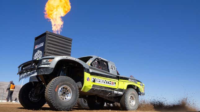 An off-road racing truck takes off from the start finish line of the Mint 400