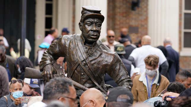 People view the statue honoring Black enslaved men who enlisted in the U.S. Colored Troops and served in the Civil War after it was unveiled Saturday, Oct. 23, 2021, in Franklin, Tenn. Artist Joe Howard was commissioned by The Fuller Story Project in Franklin to create a bronze monument memorializing Black Civil War Union Army soldiers. 