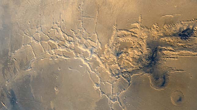 Noctis Labyrinthus, whose eastern end hides a heavily eroded giant volcano.
