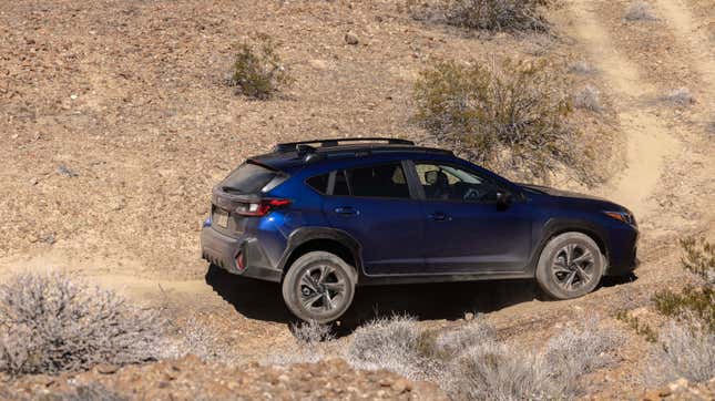 A blue crosstrek off roading in the desert