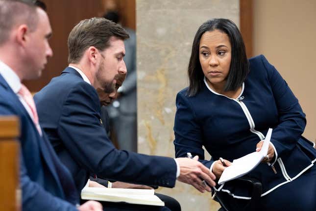 Fulton County District Attorney Fani Willis, right, talks with a member of her team during proceedings to seat a special purpose grand jury in Fulton County, Georgia, on Monday, May 2, 2022.