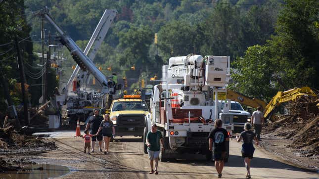 eople view damage while workers clear debris from a bridge on Catawba Avenue in the aftermath of Hurricane Helene on September 29, 2024 in Old Fort, North Carolina.