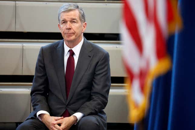 North Carolina Governor Roy Cooper listens as democratic gubernatorial candidate Josh Stein speaks at a rally at Shaw University in Raleigh, N.C., Tuesday, Oct. 10, 2023. (AP Photo/Karl B DeBlaker)