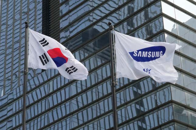 A Samsung Group flag, right, and South Korean national flag flutter at the company&#39;s office in Seoul, South Korea, Tuesday, April 30, 2024. Samsung Electronics on Tuesday reported a 10-fold increase in operating profit for the last quarter as the expansion of artificial intelligence technologies drives a rebound in the markets for computer memory chips.(AP Photo/Ahn Young-joon)